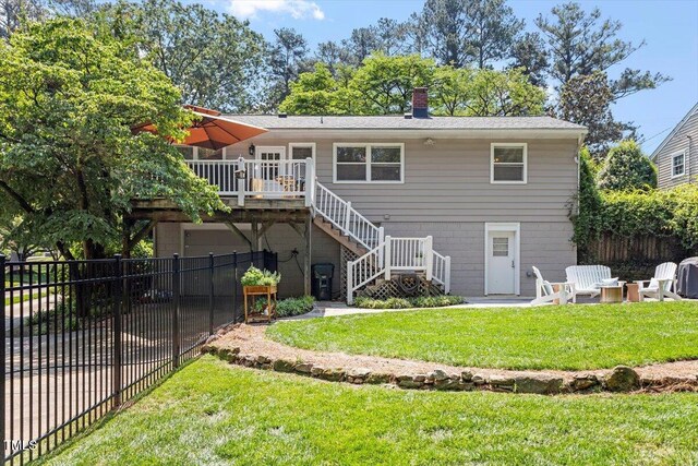 2913 Anderson Dr, Raleigh, NC 27608 - back of property featuring stairs, a deck, a chimney, and a garage