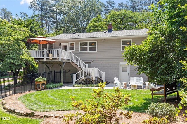 2913 Anderson Dr, Raleigh, NC 27608 - rear view of property with stairs, a wooden deck, and a chimney