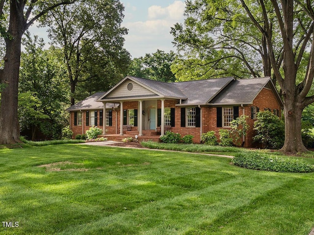 2228 Walker Ave, Burlington, NC 27215 - view of front of house with brick siding, covered porch, and a front lawn