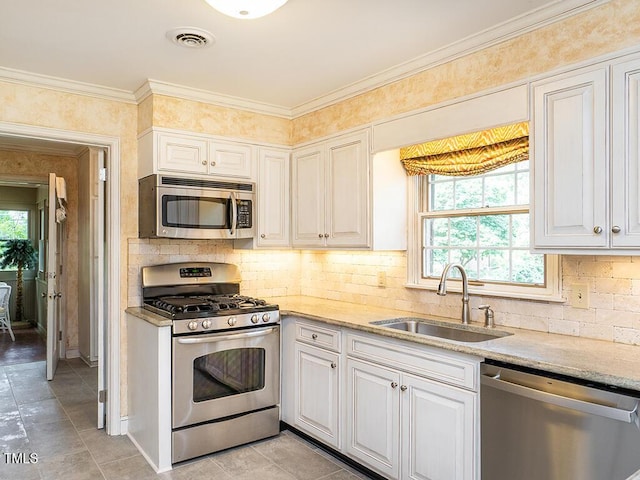 2228 Walker Ave, Burlington, NC 27215 - kitchen featuring stainless steel appliances, a sink, backsplash, light tile patterned floors, and light stone countertops