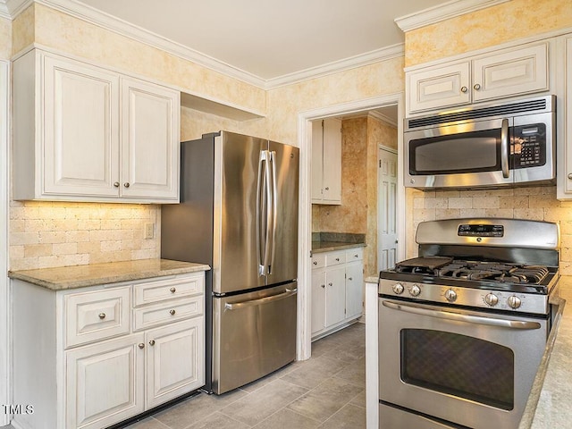 2228 Walker Ave, Burlington, NC 27215 - kitchen featuring stainless steel appliances, decorative backsplash, crown molding, light stone countertops, and light tile patterned floors