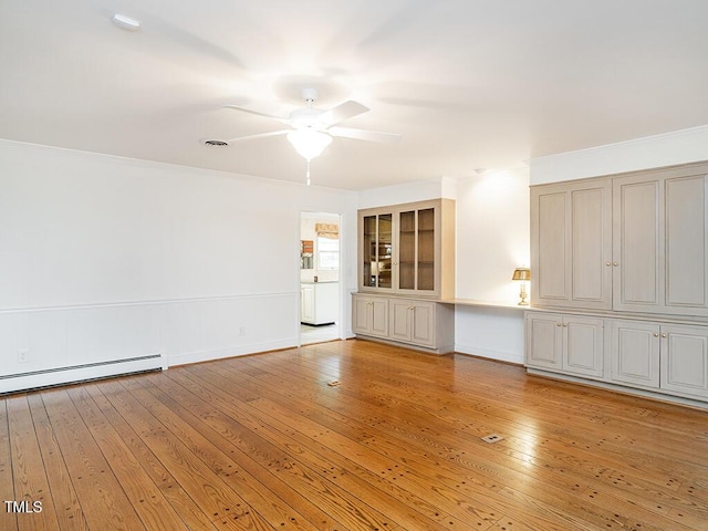 2228 Walker Ave, Burlington, NC 27215 - spare room featuring a baseboard radiator, ceiling fan, light wood-style flooring, baseboards, and ornamental molding