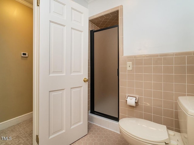 2228 Walker Ave, Burlington, NC 27215 - bathroom with toilet, a stall shower, tile walls, crown molding, and tile patterned flooring