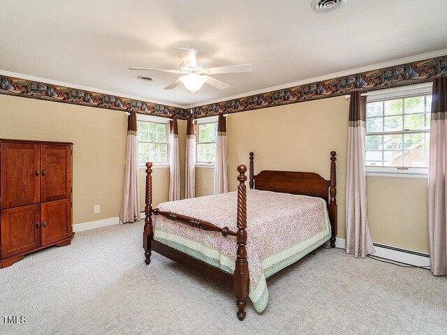2228 Walker Ave, Burlington, NC 27215 - bedroom featuring baseboard heating, light carpet, a ceiling fan, and baseboards