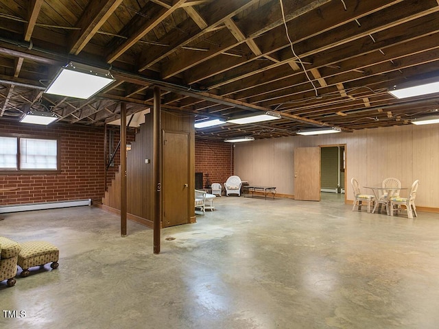 2228 Walker Ave, Burlington, NC 27215 - below grade area featuring stairs, a baseboard radiator, and brick wall