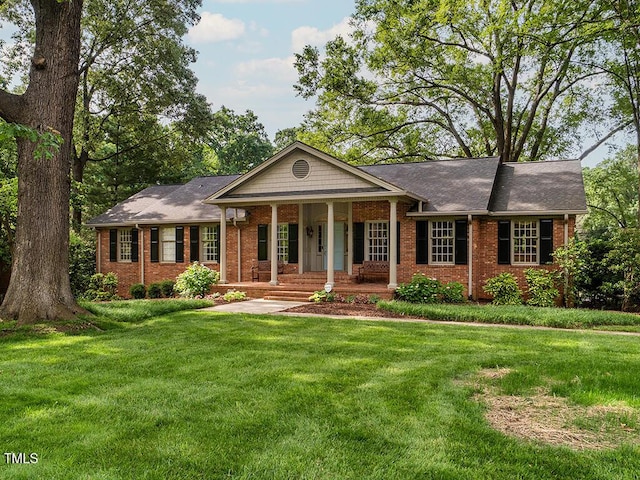2228 Walker Ave, Burlington, NC 27215 - view of front facade featuring brick siding, covered porch, and a front yard