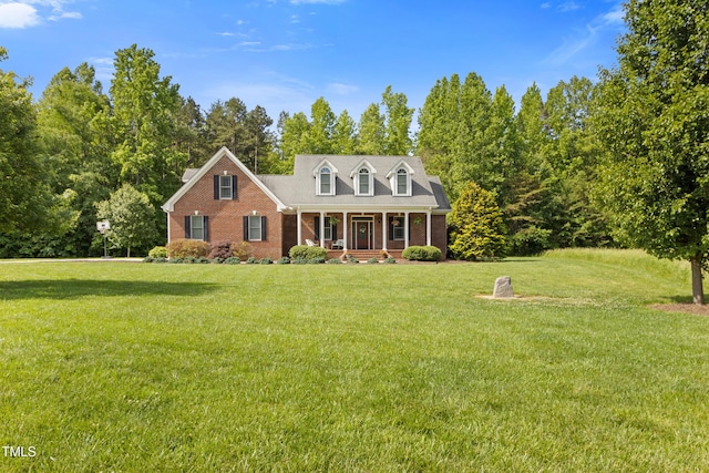 200 Daniel Ridge Ln, Roxboro, NC 27574 - cape cod-style house featuring a porch, brick siding, and a front yard