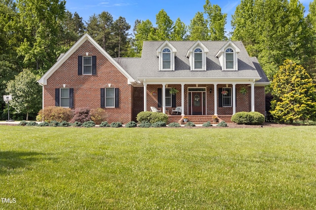 200 Daniel Ridge Ln, Roxboro, NC 27574 - cape cod house with a porch, brick siding, and a front lawn
