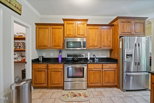 200 Daniel Ridge Ln, Roxboro, NC 27574 - kitchen with stainless steel appliances, crown molding, brown cabinetry, and dark stone countertops