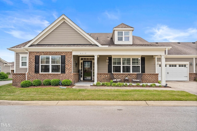 4612 Hanging Fern Ln, Raleigh, NC 27604 - view of front of property with brick siding, a porch, an attached garage, and concrete driveway
