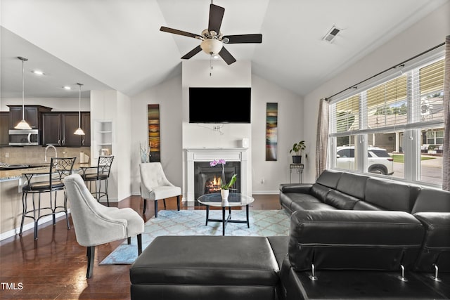 4612 Hanging Fern Ln, Raleigh, NC 27604 - living room featuring a ceiling fan, dark wood finished floors, vaulted ceiling, baseboards, and a glass covered fireplace