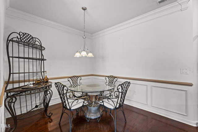 4612 Hanging Fern Ln, Raleigh, NC 27604 - dining space featuring wood finished floors, ornamental molding, wainscoting, a chandelier, and a decorative wall