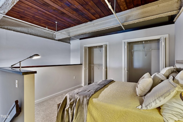 bedroom featuring two closets, carpet, baseboards, and wood ceiling