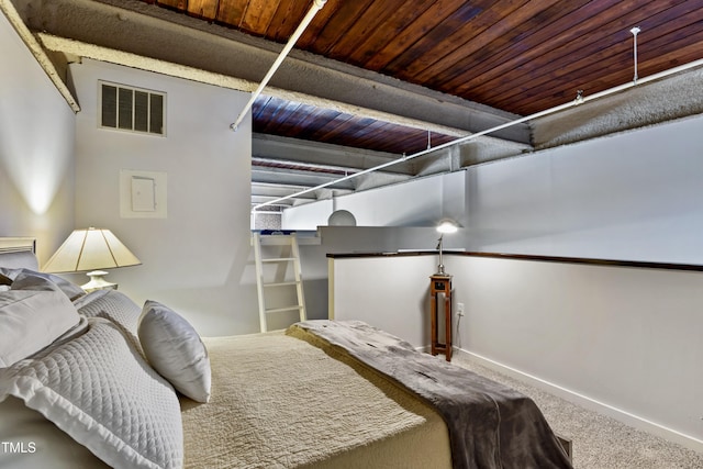 carpeted bedroom featuring baseboards and wood ceiling