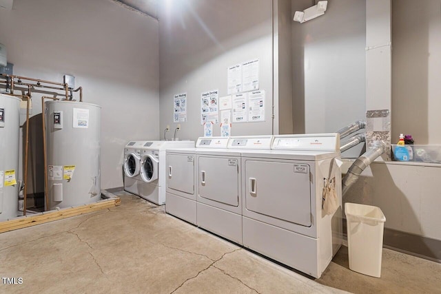 community laundry featuring washer and clothes dryer and electric water heater