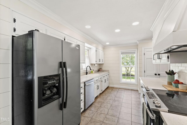 5413 Lower Creek Ct, Apex, NC 27539 - kitchen with appliances with stainless steel finishes, custom exhaust hood, a sink, light countertops, and ornamental molding
