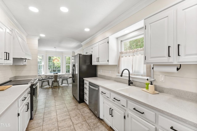5413 Lower Creek Ct, Apex, NC 27539 - kitchen with stainless steel appliances, a sink, plenty of natural light, white cabinetry, and ornamental molding