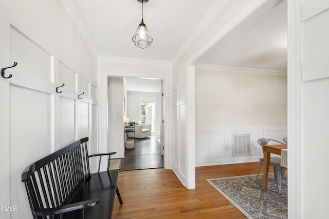 5413 Lower Creek Ct, Apex, NC 27539 - corridor with light wood-style floors, ornamental molding, and wainscoting