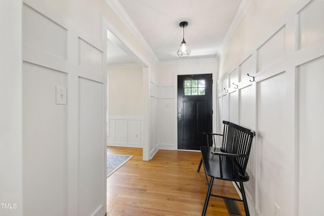 5413 Lower Creek Ct, Apex, NC 27539 - entryway with a decorative wall, crown molding, light wood finished floors, and wainscoting