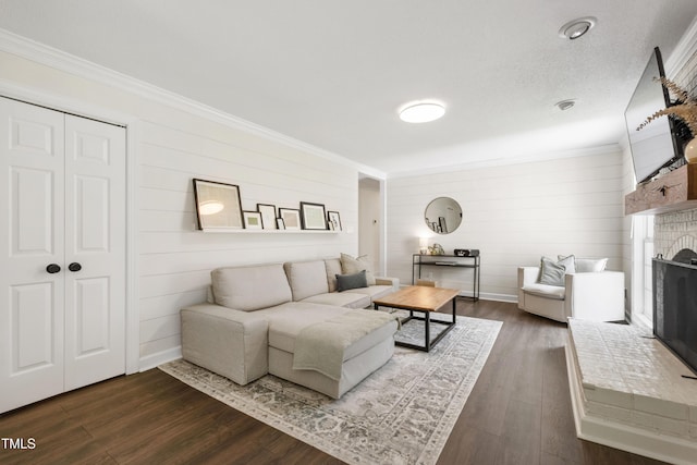 5413 Lower Creek Ct, Apex, NC 27539 - living room with crown molding, dark wood-type flooring, a brick fireplace, wooden walls, and baseboards