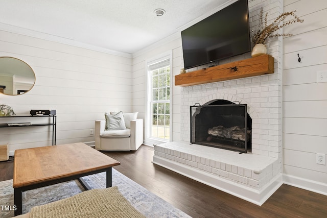 5413 Lower Creek Ct, Apex, NC 27539 - living room with wood finished floors, crown molding, a brick fireplace, wooden walls, and baseboards