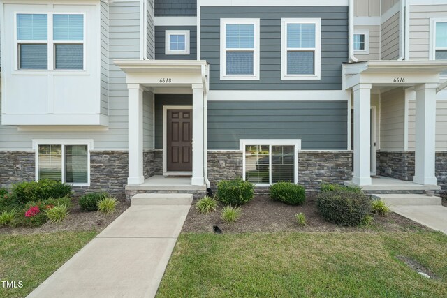 6618 Perry Creek Rd, Raleigh, NC 27616 - property entrance with stone siding and a yard