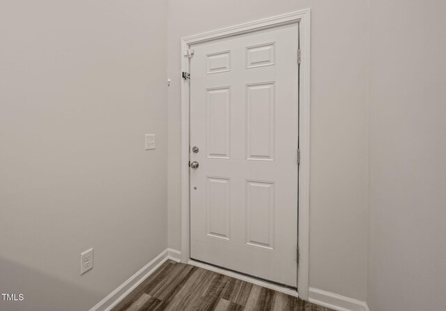 6618 Perry Creek Rd, Raleigh, NC 27616 - doorway featuring baseboards and dark wood-style floors