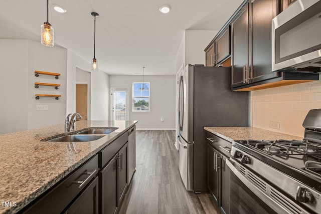 6618 Perry Creek Rd, Raleigh, NC 27616 - kitchen with appliances with stainless steel finishes, a sink, backsplash, light stone countertops, and dark wood finished floors