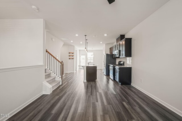 6618 Perry Creek Rd, Raleigh, NC 27616 - kitchen featuring appliances with stainless steel finishes, light countertops, dark wood-style flooring, a center island with sink, and recessed lighting
