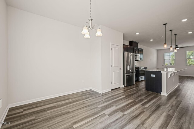 6618 Perry Creek Rd, Raleigh, NC 27616 - kitchen with stainless steel appliances, recessed lighting, dark wood-style flooring, a breakfast bar, and a chandelier