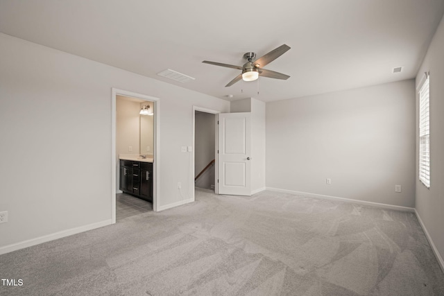 6618 Perry Creek Rd, Raleigh, NC 27616 - unfurnished bedroom with light carpet, baseboards, and connected bathroom