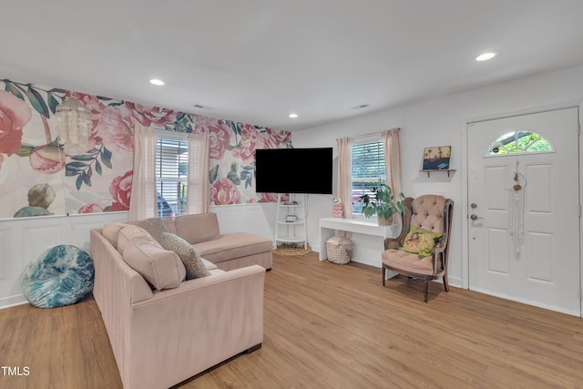 living area with light wood-style flooring, recessed lighting, and wallpapered walls