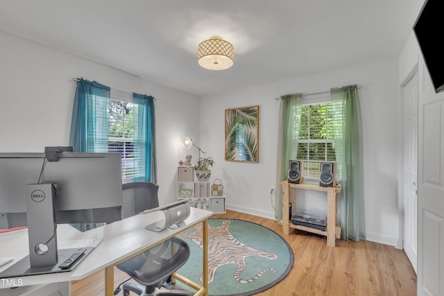 office featuring light wood-type flooring and baseboards