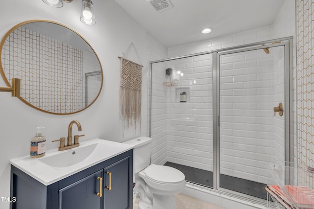 full bath with a stall shower, toilet, and vanity