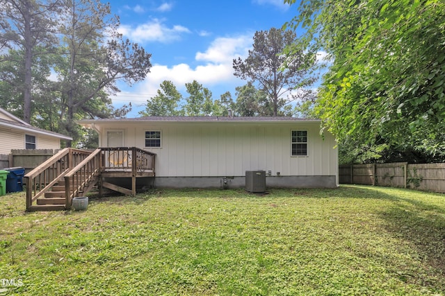 rear view of property featuring a wooden deck, central AC unit, and stairs