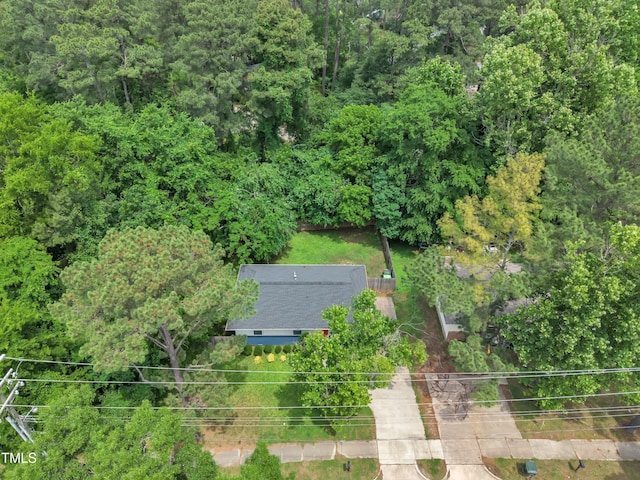 aerial view of property and surrounding area with a forest