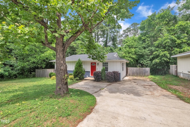 view of front of home featuring concrete driveway, roof with shingles, and board and batten siding