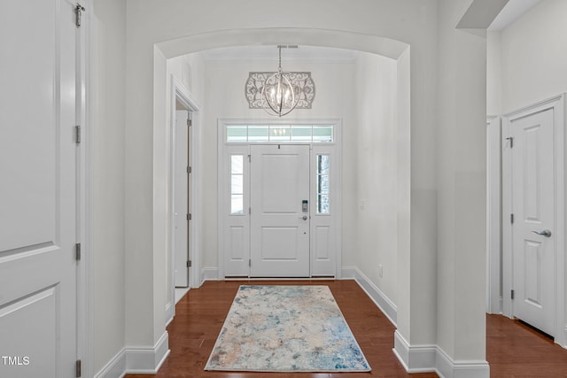 2511 Range Overlook Xing, Apex, NC 27523 - foyer entrance featuring a chandelier, arched walkways, and dark wood-type flooring
