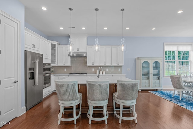 2511 Range Overlook Xing, Apex, NC 27523 - kitchen featuring stainless steel appliances, light countertops, dark wood-style flooring, decorative backsplash, and white cabinetry