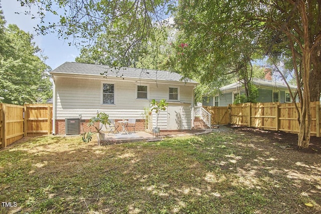 back of property featuring a fenced backyard, central air condition unit, and stairs