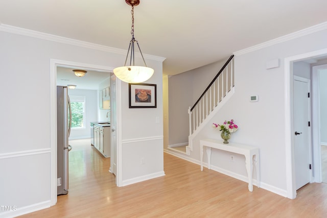 2222 Pathway Dr, Chapel Hill, NC 27516 - foyer entrance with light wood finished floors, ornamental molding, and stairs