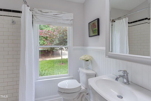 2222 Pathway Dr, Chapel Hill, NC 27516 - bathroom featuring a wainscoted wall and tiled shower