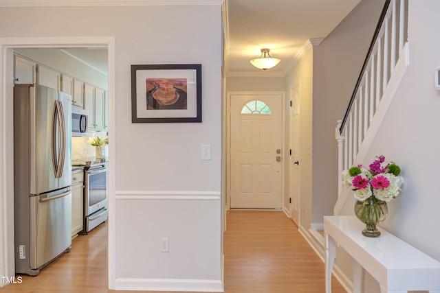 2222 Pathway Dr, Chapel Hill, NC 27516 - entrance foyer with ornamental molding, light wood finished floors, and stairway