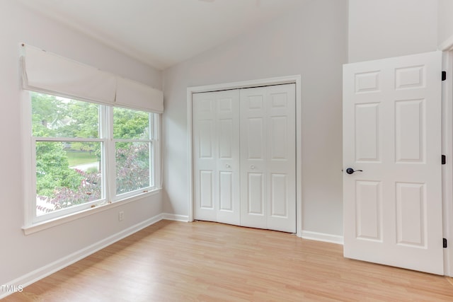 2222 Pathway Dr, Chapel Hill, NC 27516 - unfurnished bedroom with lofted ceiling, light wood finished floors, and a closet