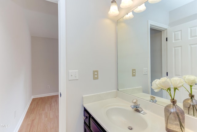 2222 Pathway Dr, Chapel Hill, NC 27516 - bathroom with vanity, wood finished floors, and a chandelier