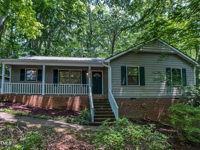 1104 Theresa Ct, Raleigh, NC 27615 - view of front of home featuring a porch, stairs, and crawl space
