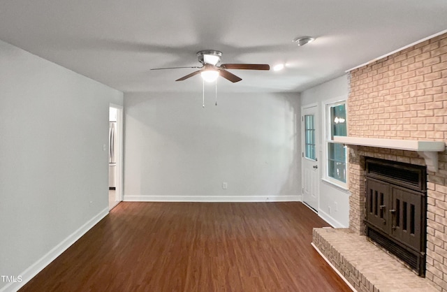 1104 Theresa Ct, Raleigh, NC 27615 - unfurnished living room with wood finished floors, a ceiling fan, a brick fireplace, and baseboards
