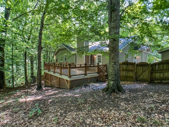 1104 Theresa Ct, Raleigh, NC 27615 - rear view of property with a gate, a wooden deck, a chimney, and fence