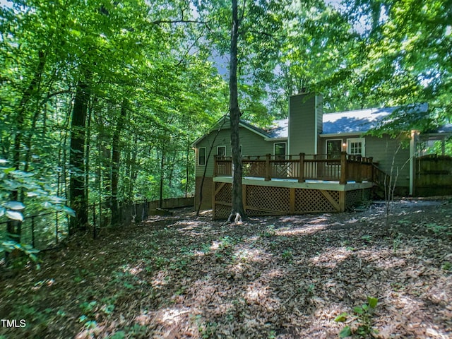 1104 Theresa Ct, Raleigh, NC 27615 - rear view of property featuring a chimney, a wooden deck, and fence