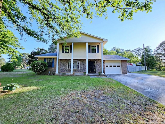 6261 Stoney Point Loop, Fayetteville, NC 28306 - view of front of property featuring driveway, a garage, a porch, and stone siding